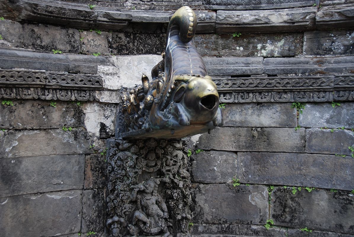 Kathmandu Bhaktapur 05-2 Bhaktapur Durbar Square Naga Pokhari Goats Head Water Spout Water pours from a goat�s head that protrudes from the mouth of a crocodile demon in the Naga Pokhari in the Palace of 55 Windows in Bhaktapur�s Durbar Square.
